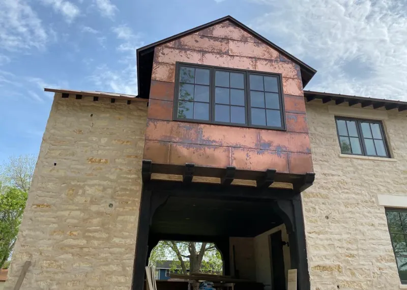 Copper metal panel facade on a stone building for Roof Repair in Kendall West